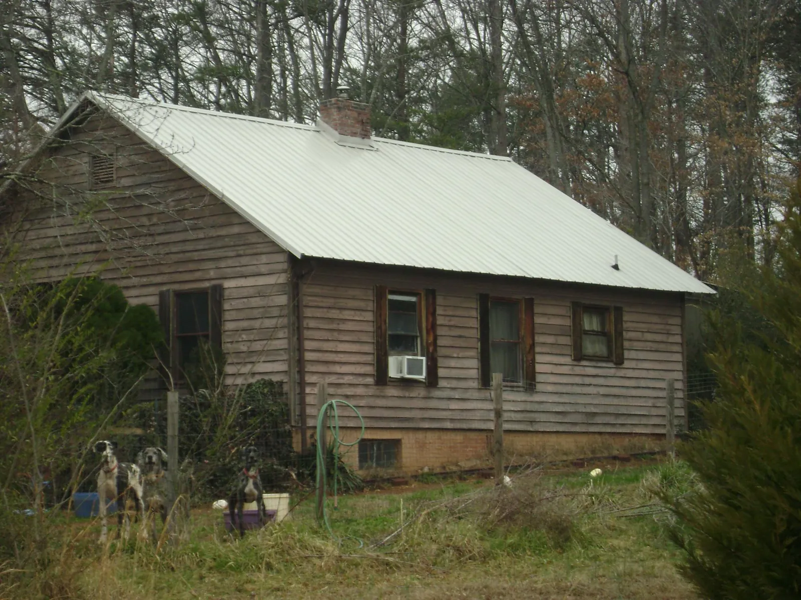 White metal roof on an old wood sided farmhouse, from a Metal Roof Installation job in Middletown